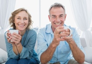 Smith Surgery-Older couple smiling hold coffee mugs